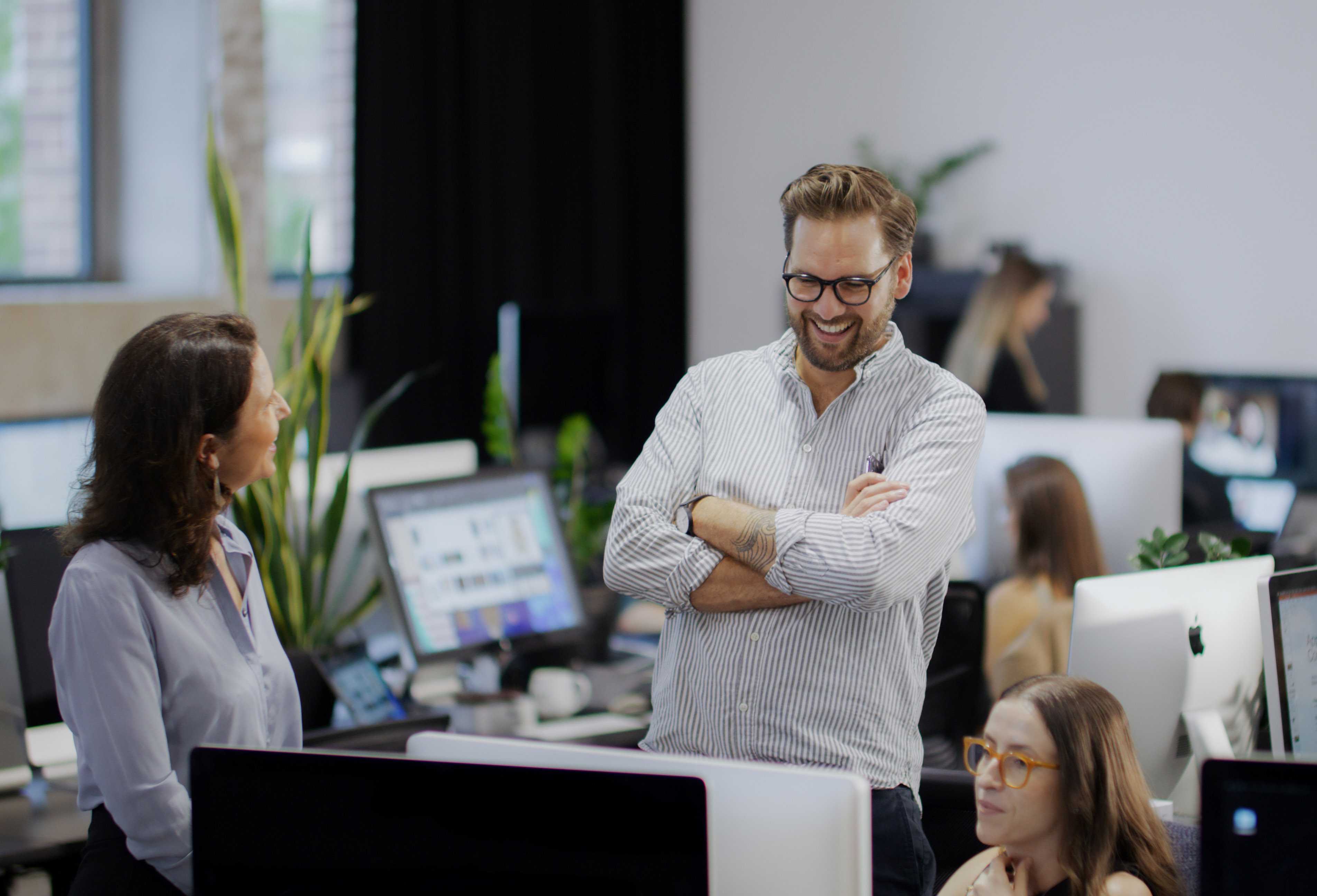 Photo of a collaborative discussion at The Being Group offices.